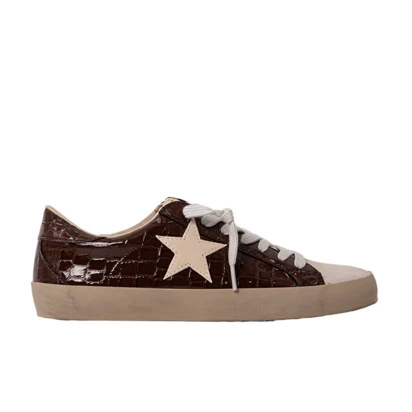 Brown sneaker with a white star on a white background