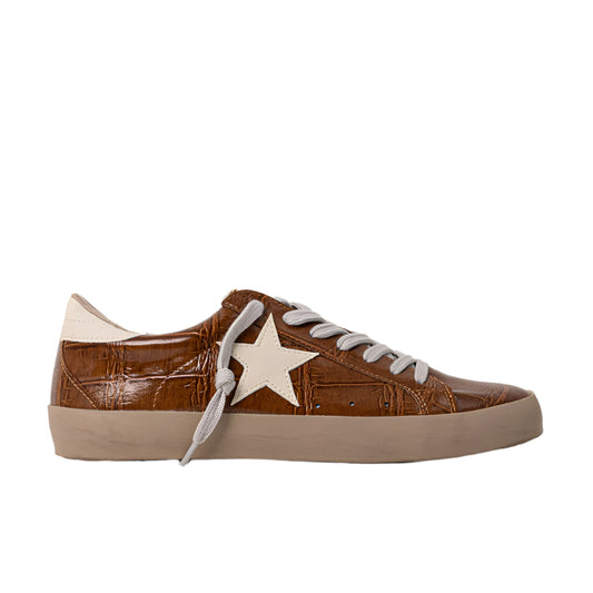 Brown sneaker with a white star on a light gray background