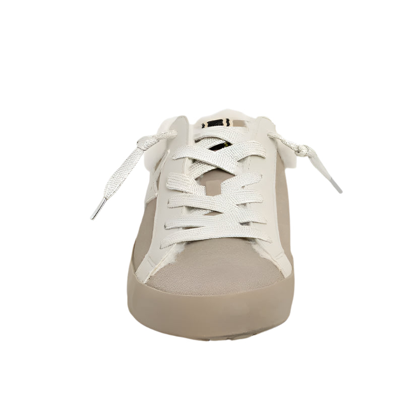 Beige sneaker with white laces on a light gray background